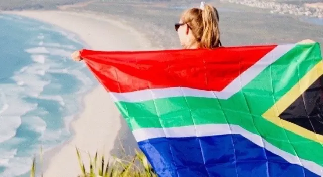 a girl holding a South African flag