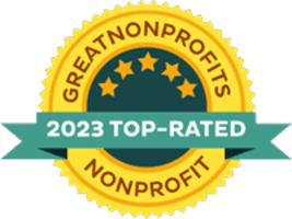 Gold medal with green banner indicating 2023 Top-Rated Nonprofit by GreatNonprofits