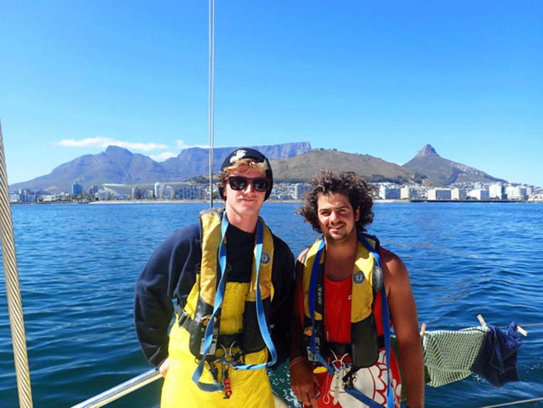 Men on a sailboat off the coast of Cape Town, South Africa