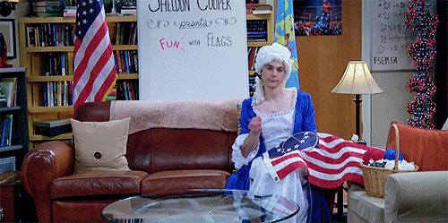 Sheldon from the Big Bang Theory in a womens costume sewing the American flag