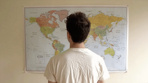 Different people standing in front of a world map.