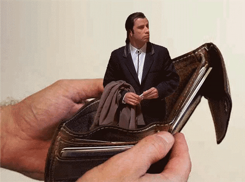 Confused John Travolta standing inside of empty wallet