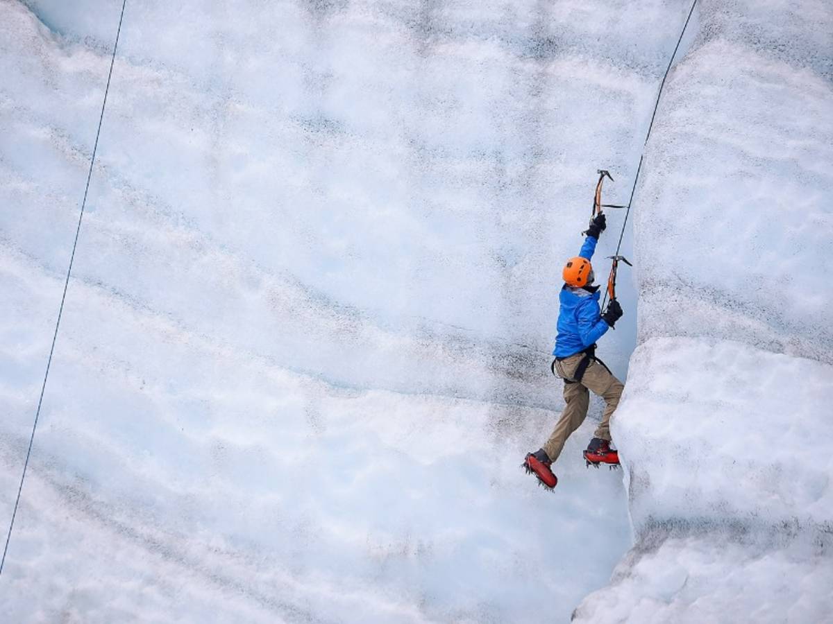 A boy ice climbing in Alaska