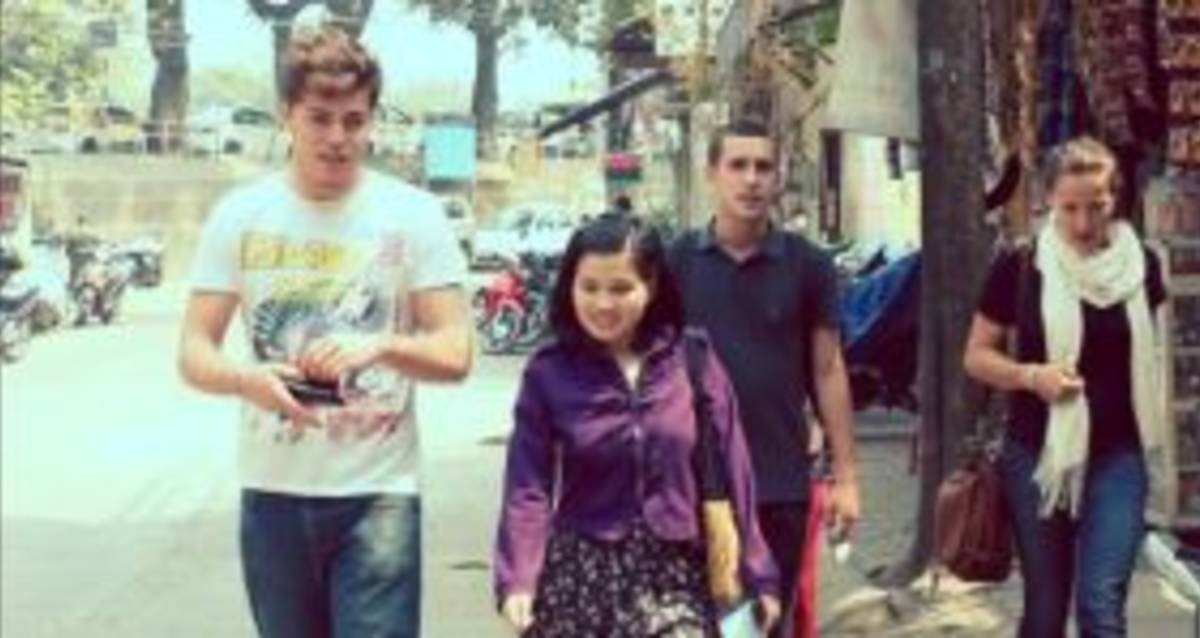 A diverse group of people walking down a city street.