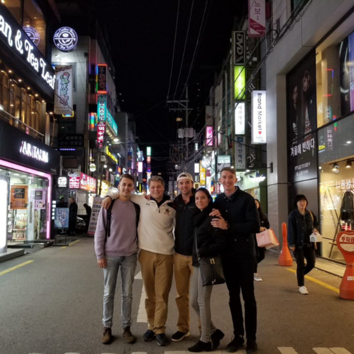 A group of students posing in nightlife in downtown Seoul