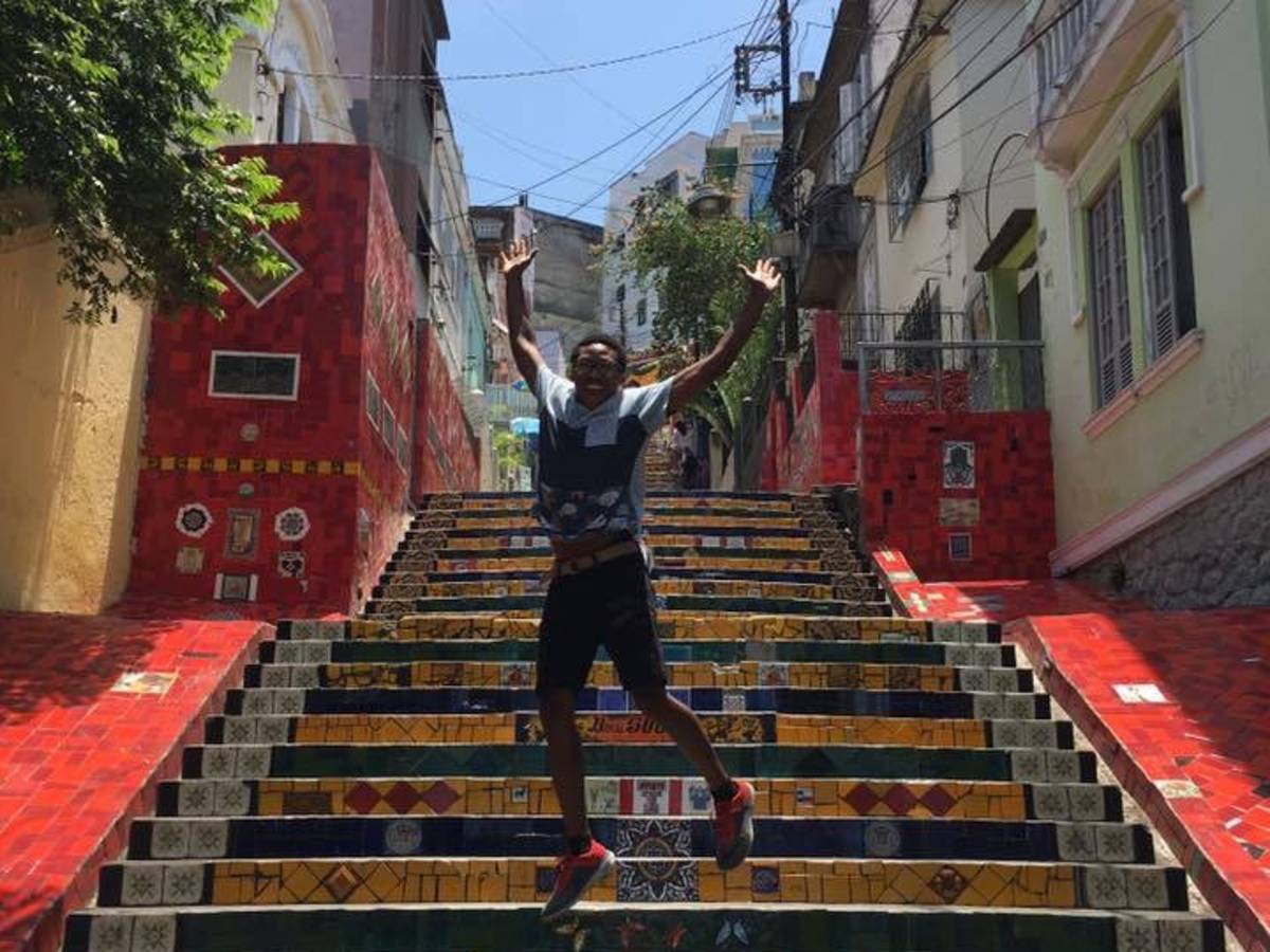 A student jumping on colorful stairs
