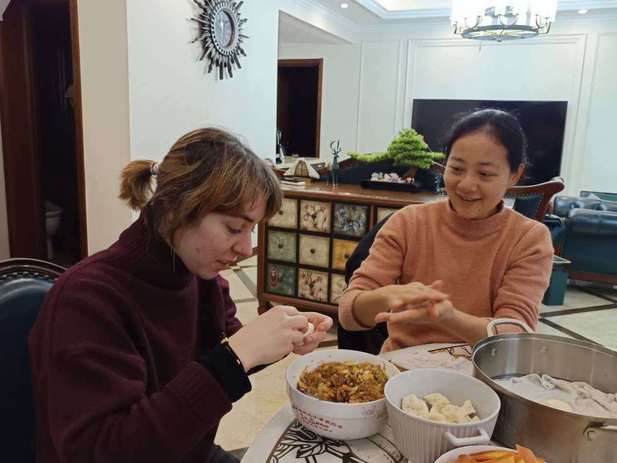 A student learning to cook a local dish in Chongqing