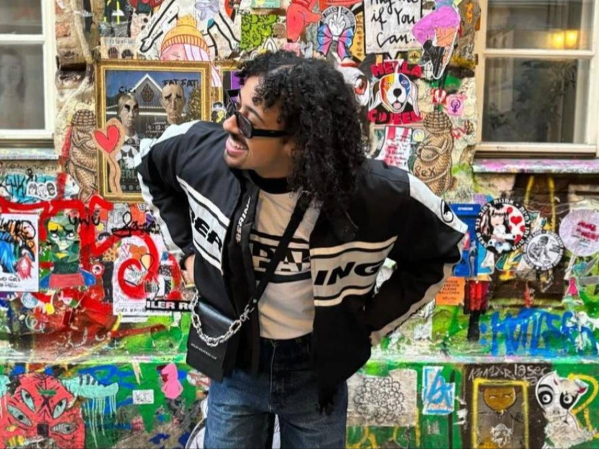 A student poses in front of a graffiti-covered wall in Berlin, Germany.