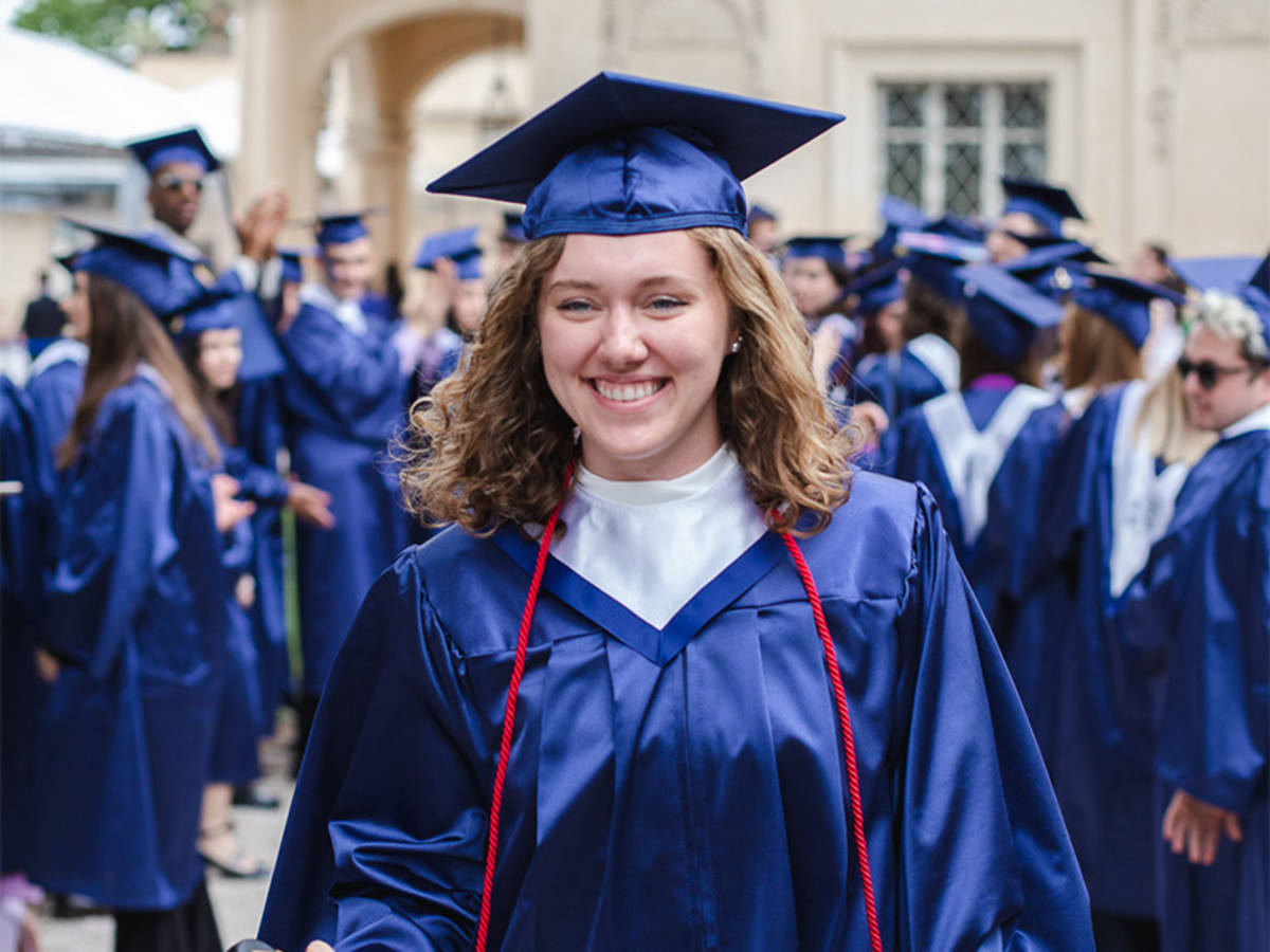 A student smiling in a cap and gown