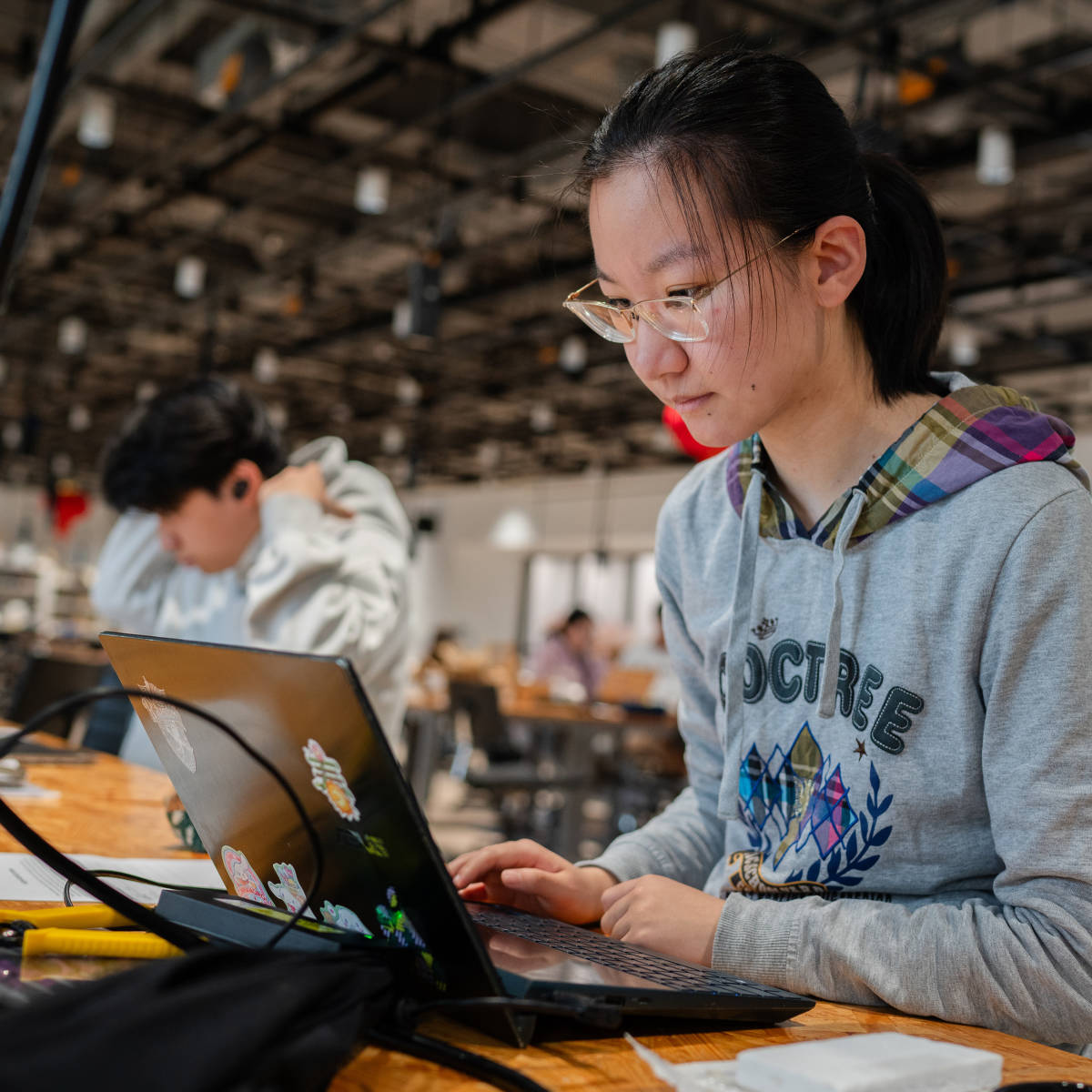 A student works on a laptop.