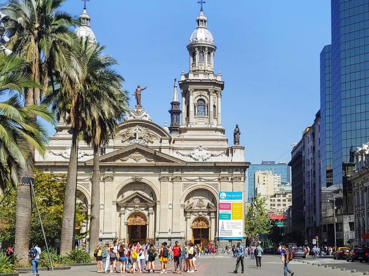a town square with historic and modern buildings in downtown Santiago
