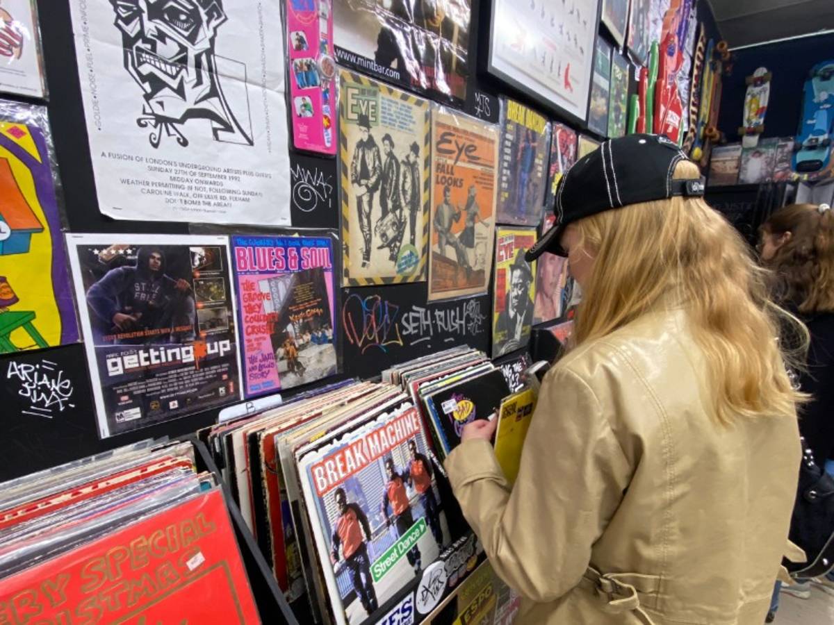 A woman looking through vinyls in a record store in the UK