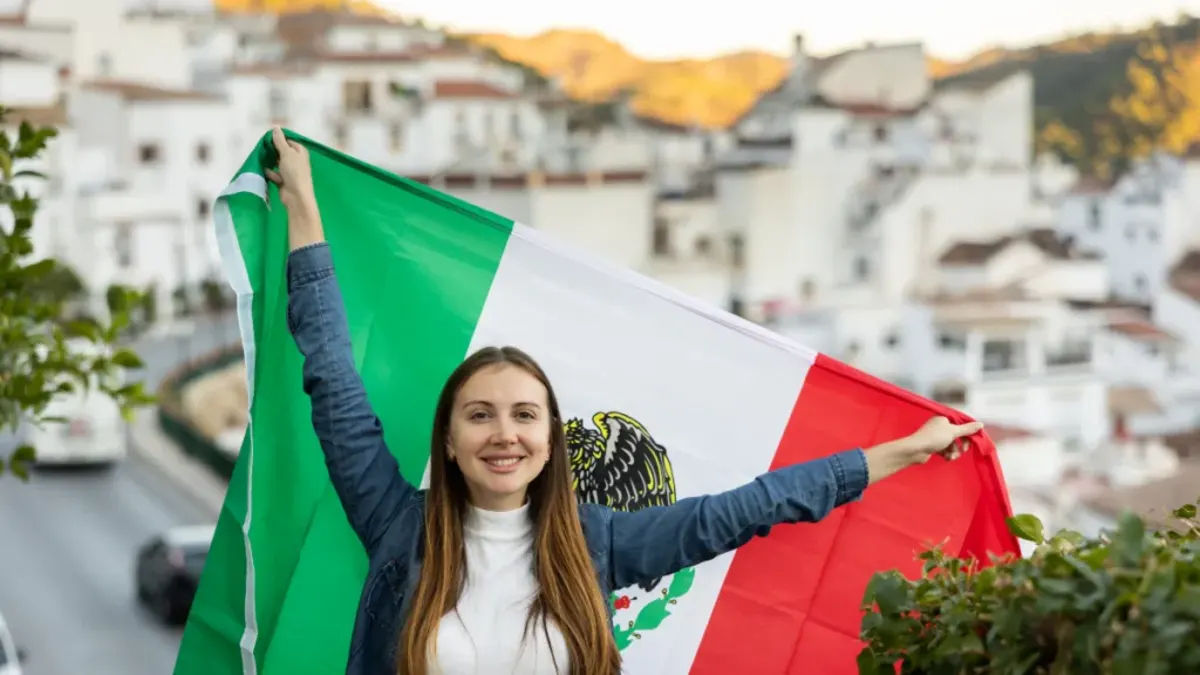 AFS student in Mexico holding the country flag