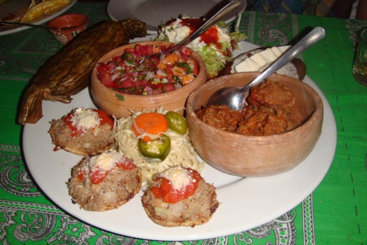 Assorted Mexican food dishes served on a table with colorful ingredients and traditional flavors.