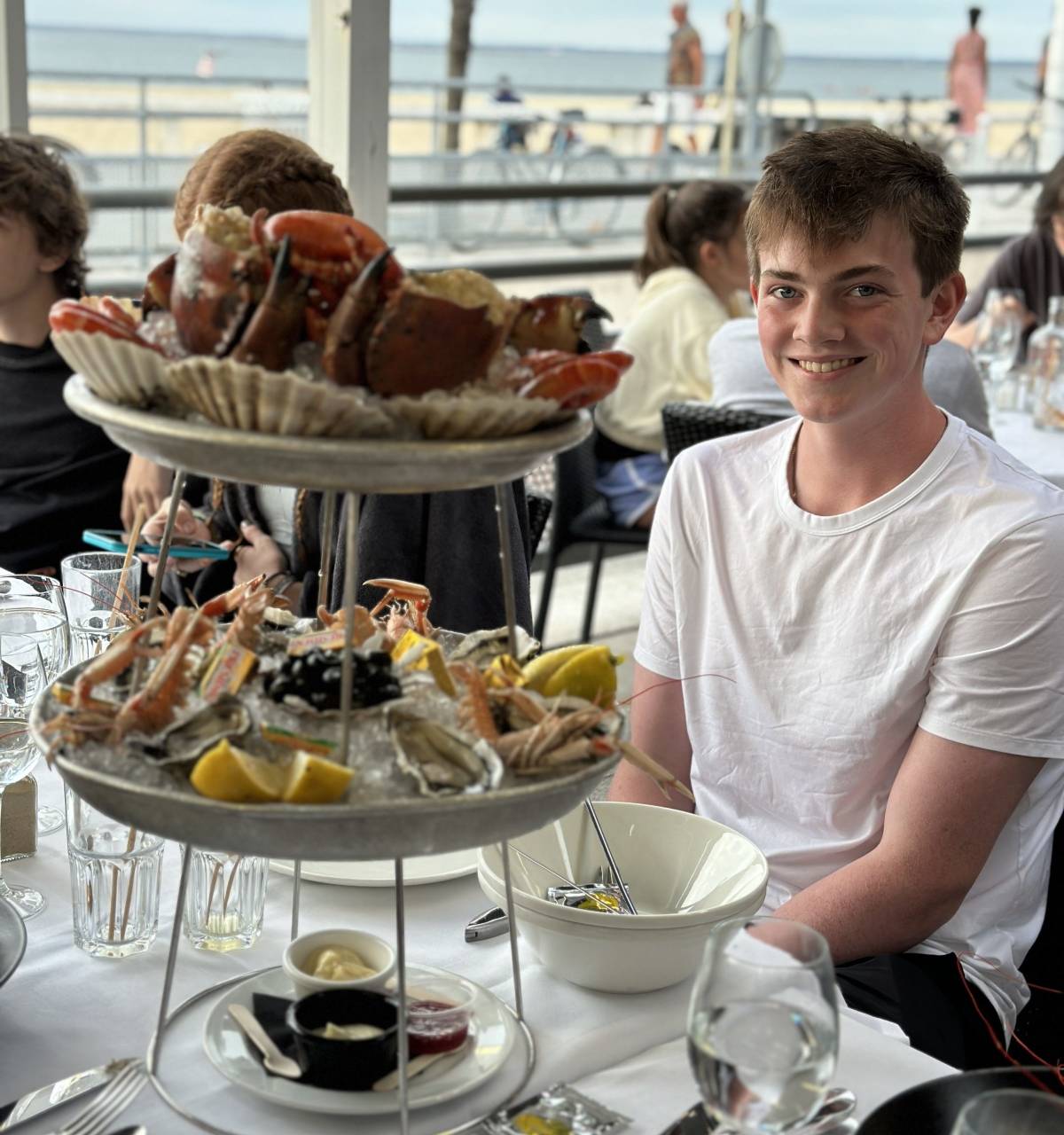 Boy in front a seafood tower