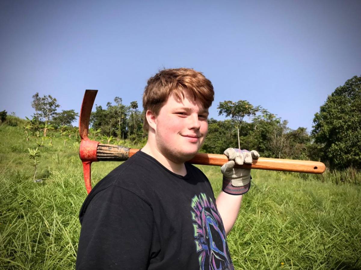 Boy posing with tool during service work