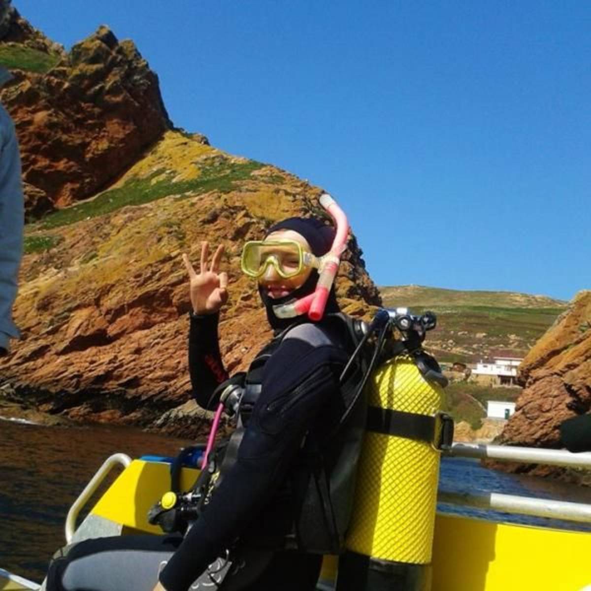 volunteer with diving equipment on a boat