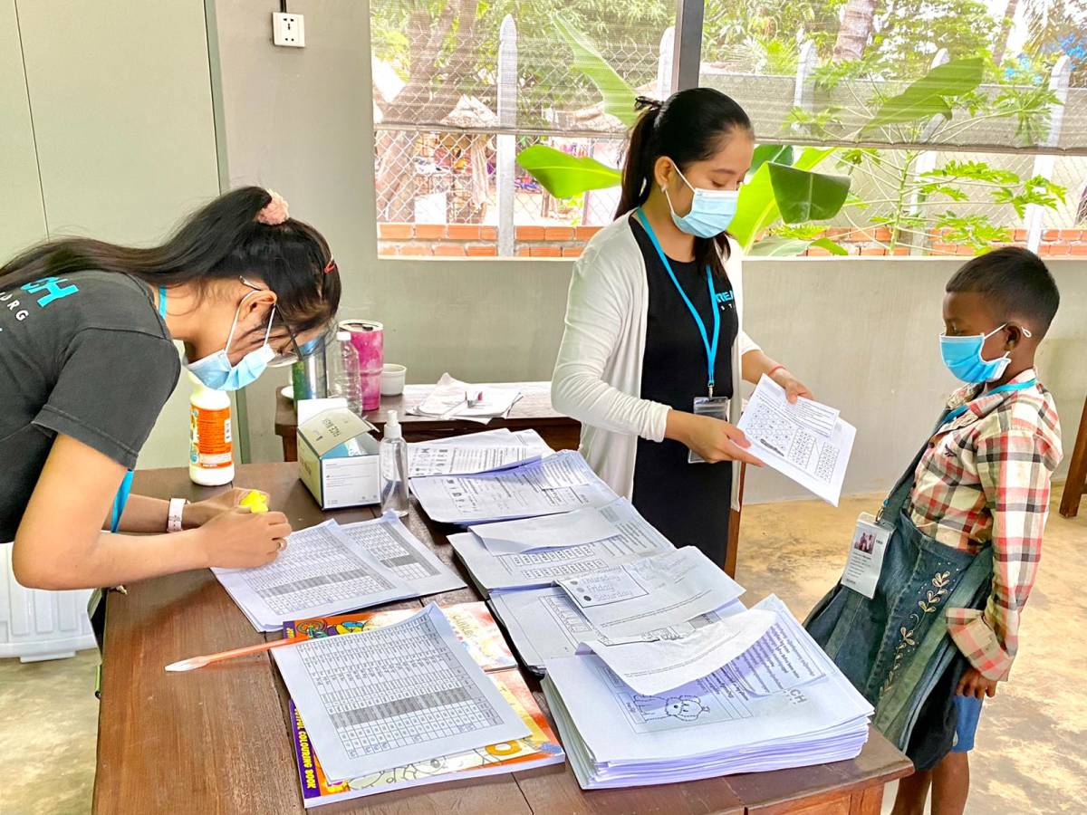 Education Program Development Interns with local boy in Cambodia