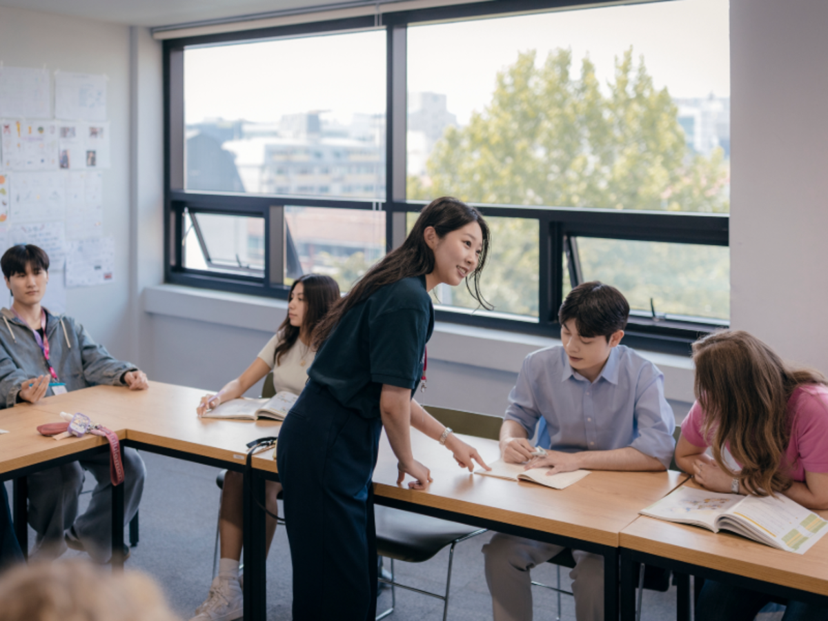 EF students in a Seoul classroom studying Korean with a teacher guiding them through exercises.