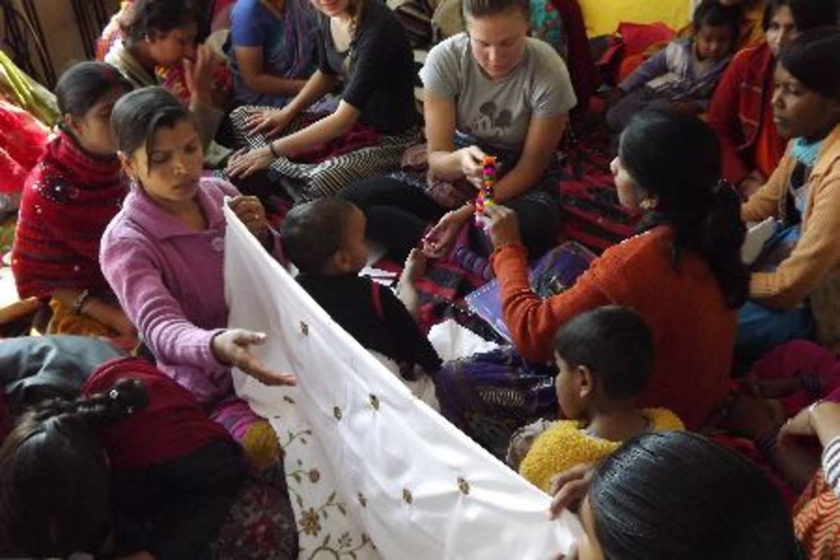 Volunteers with locals working on cloths