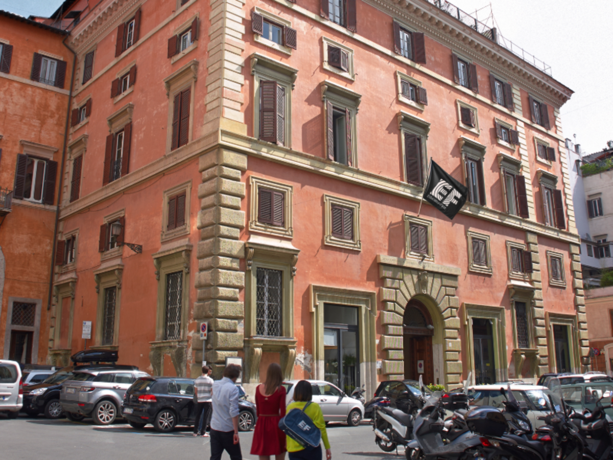 Exterior of the EF Rome campus housed in a historic Italian building with students walking nearby.