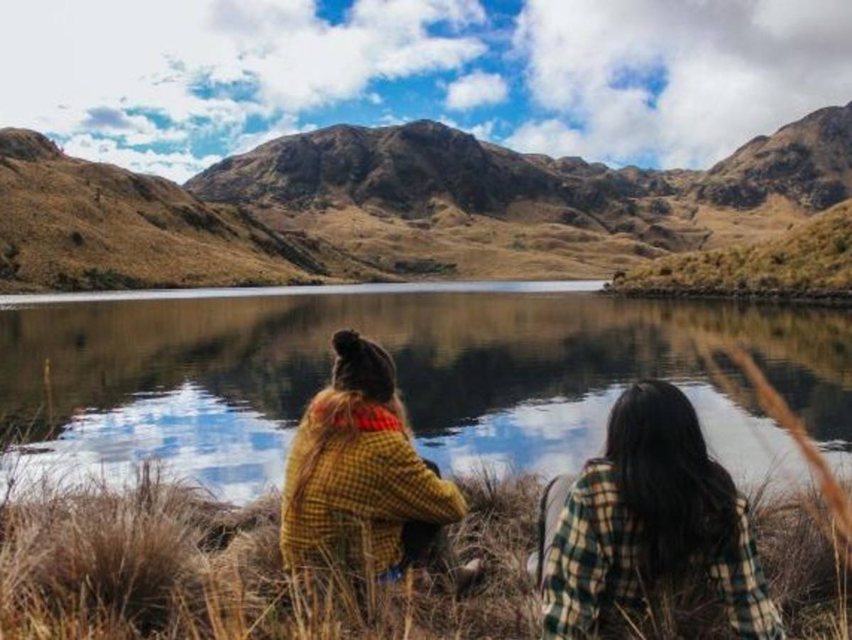 Friends look out at a lake in Ecuador on a field trip.
