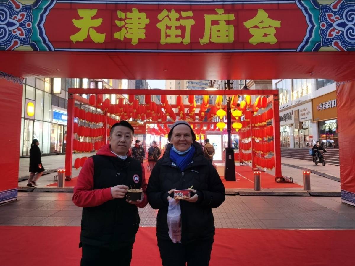 Grace visiting a food market with her teacher in Dalian