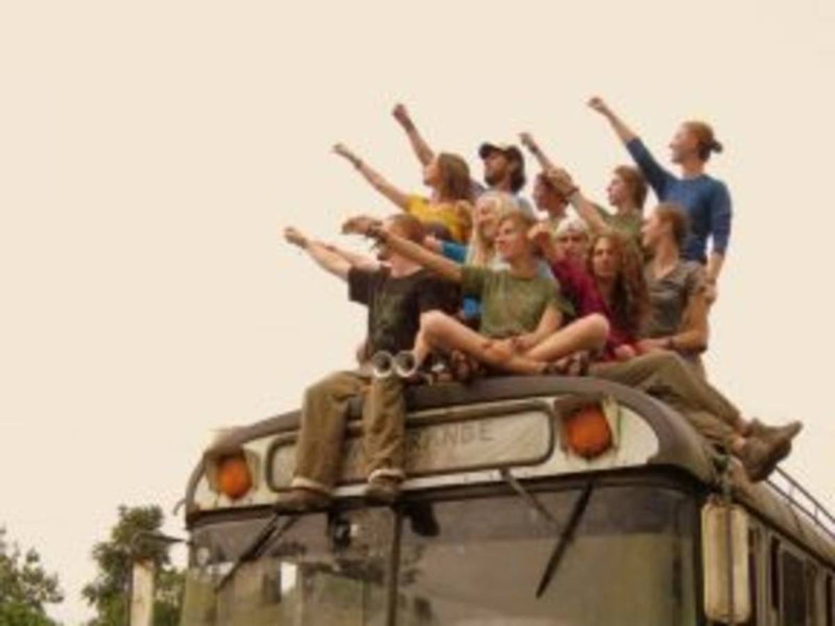 group of people with their fist up on top of a bus