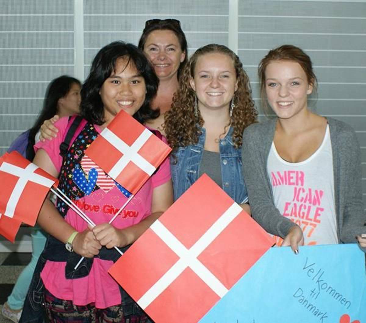 A group of high school students holding Danish flags in Denmark.