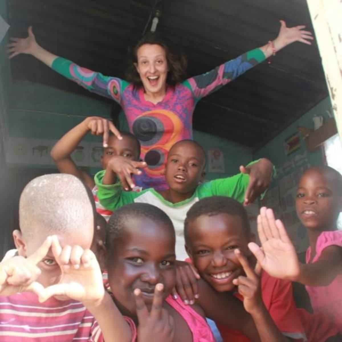 volunteer playing with children outside