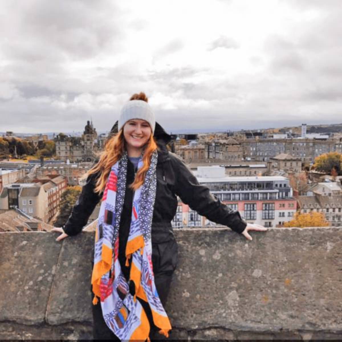 Student posed in front of the city skyline