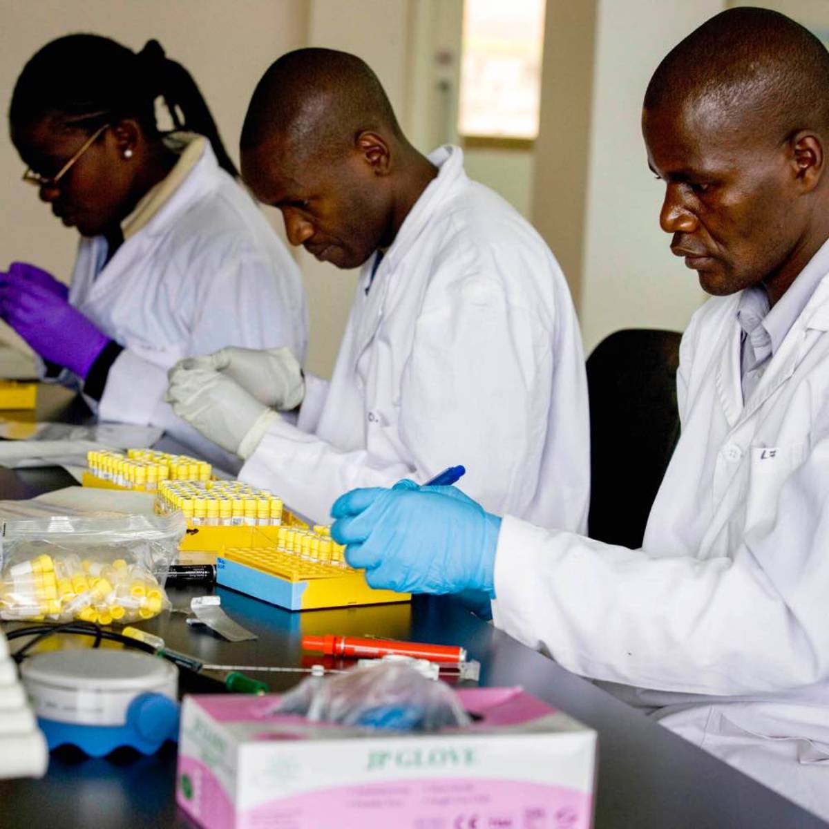 Kenyan doctors working with medical test tubes