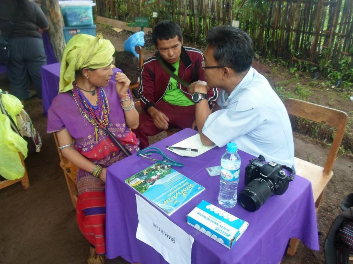 Doctor speaking with locals in Thailand