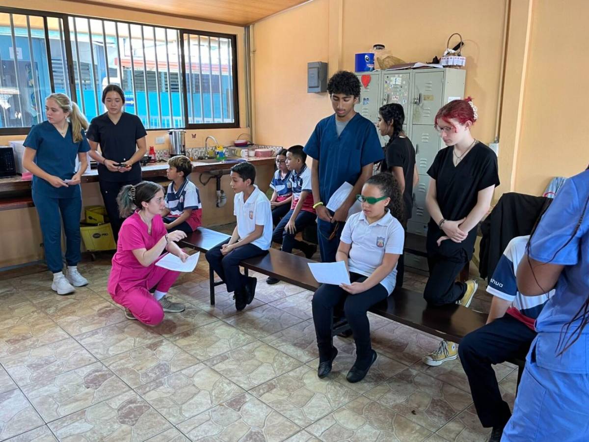 Medical students helping children with their vision tests