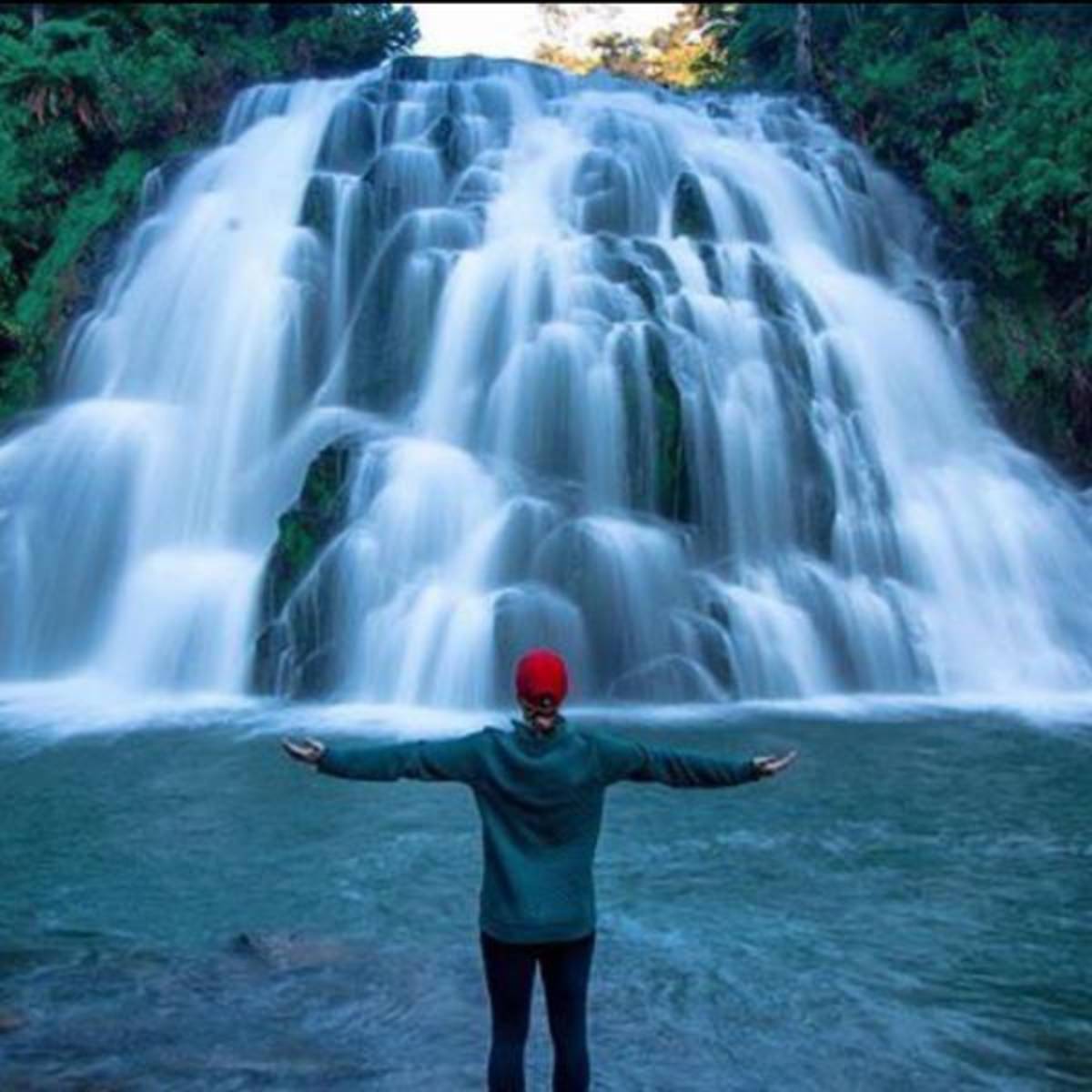 Student in front of waterfalls
