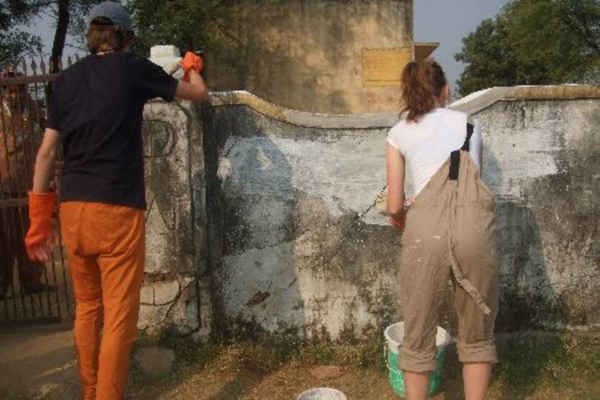 Volunteers painting a wall