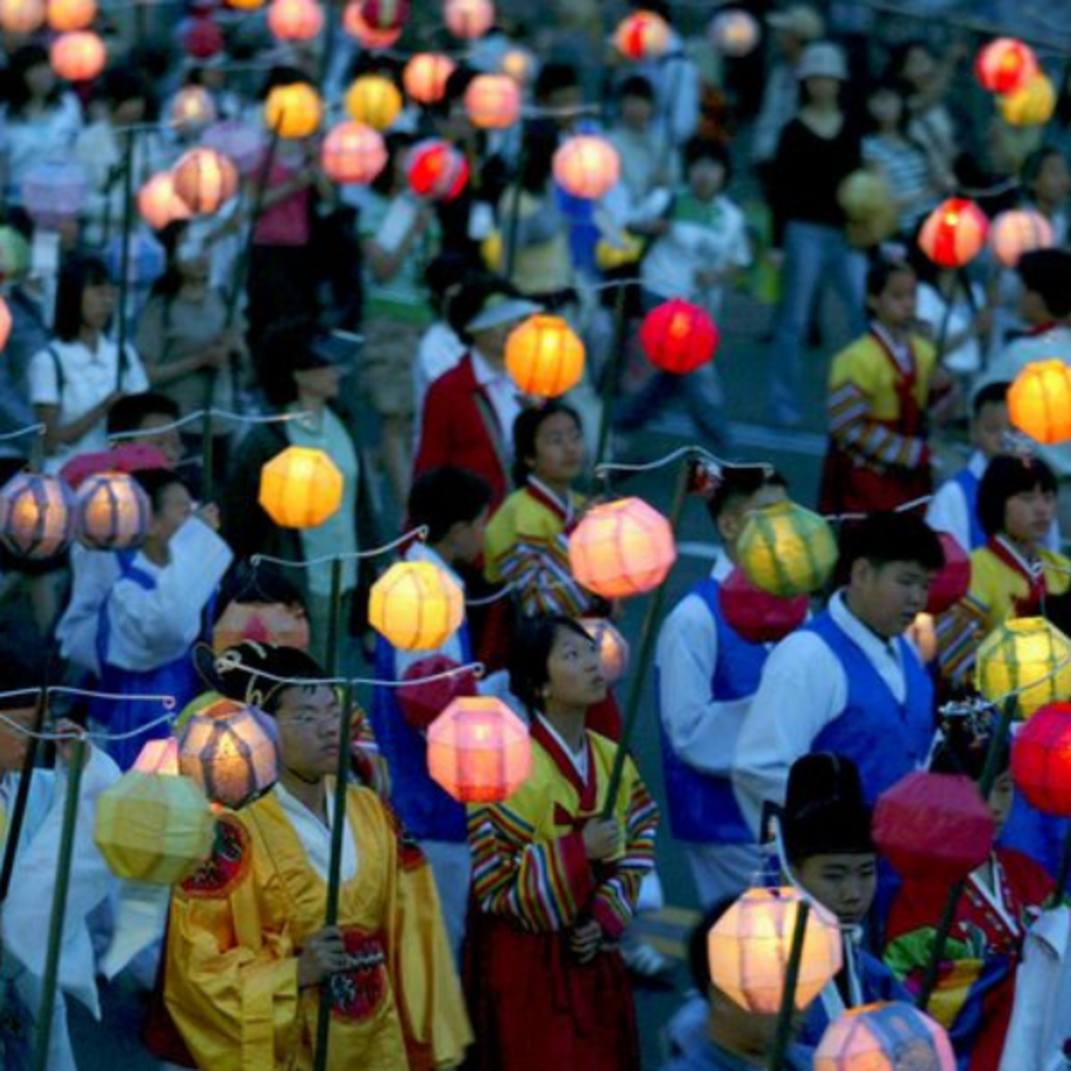 People holding up lanterns
