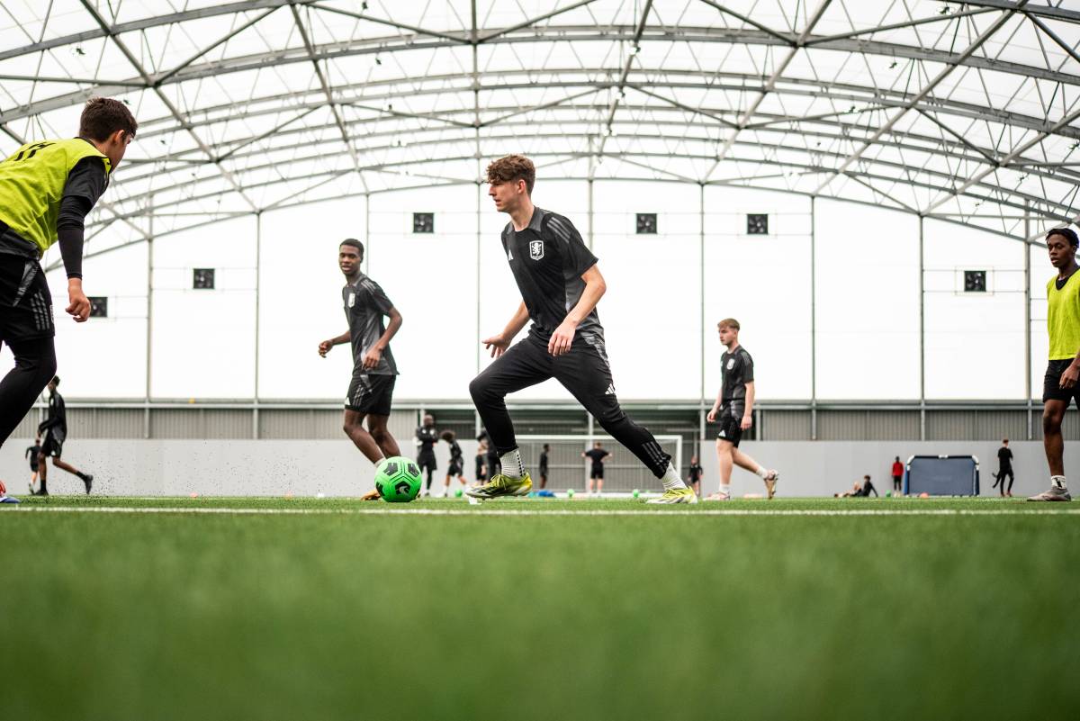 people playing soccer in an indoor field