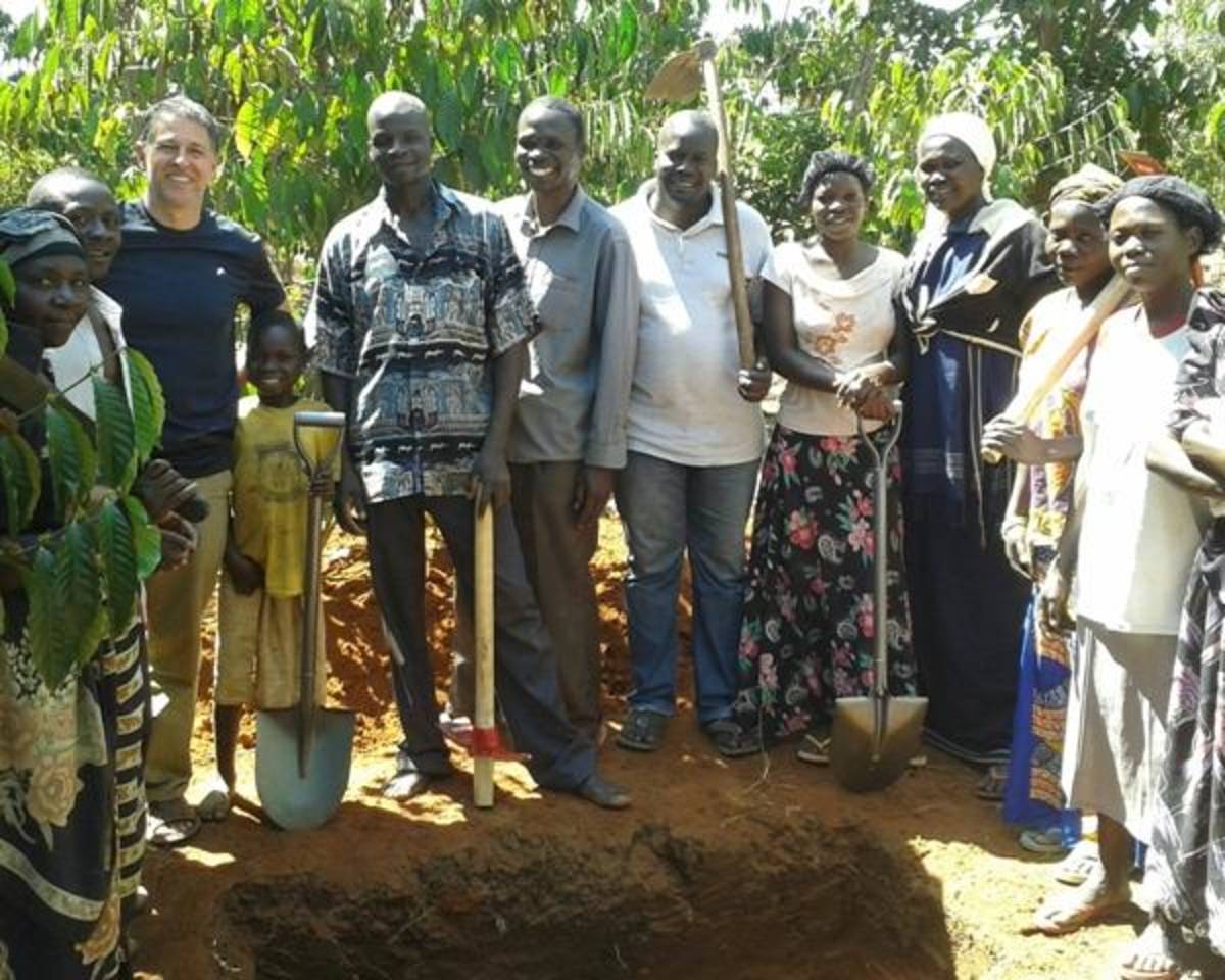 public health volunteers help dig pit latrines in rural Uganda