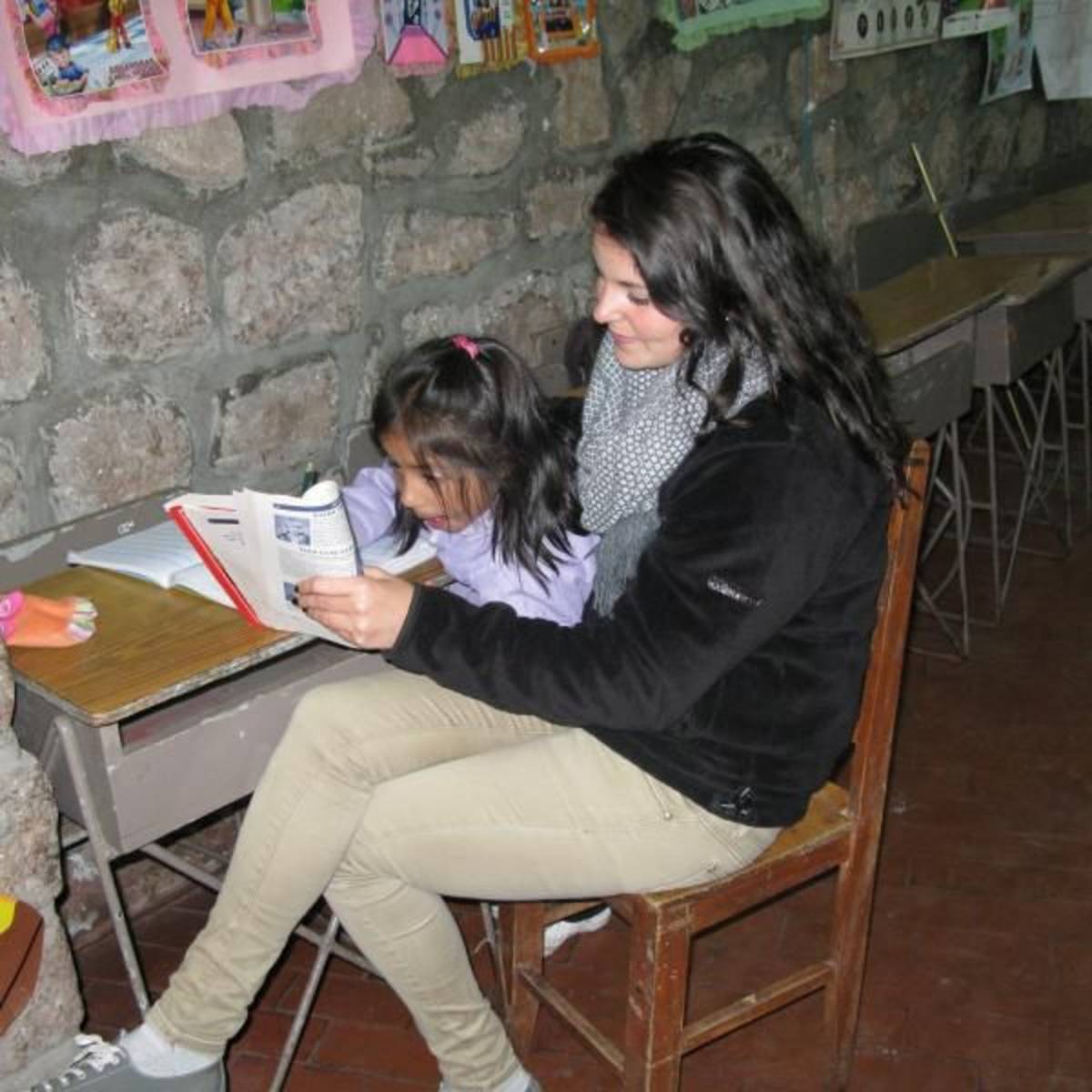 Intern assists a student at school in Cusco Peru