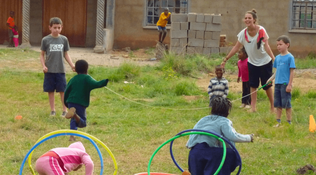 Volunteer and children playing