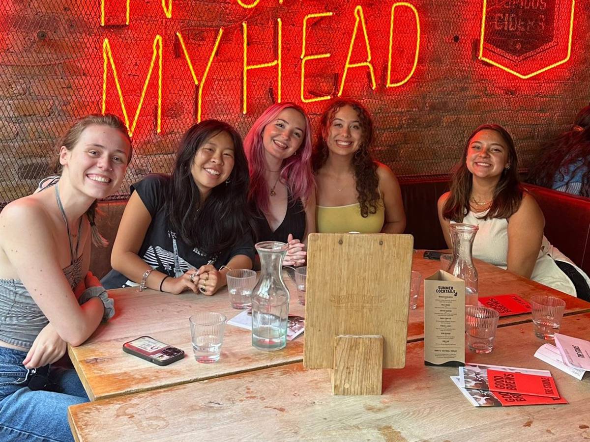 Smiling girls sat at a table having dinner