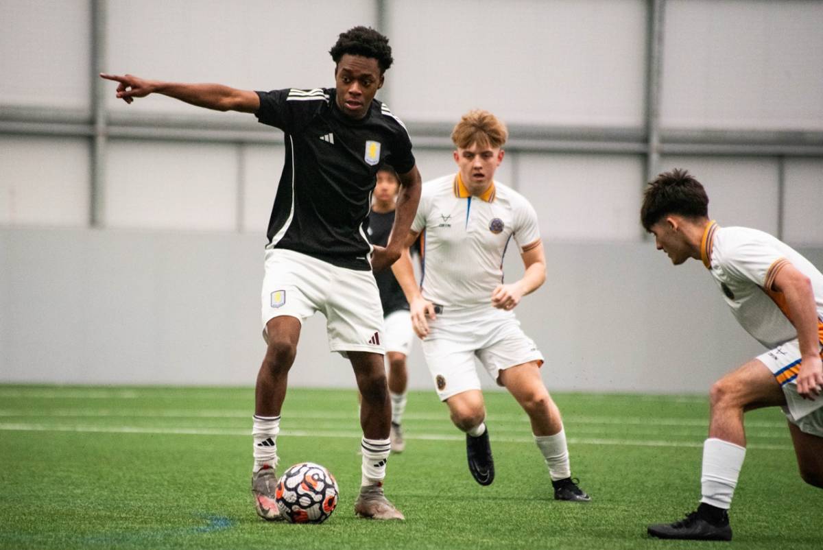 soccer player pointing at team mate while playing on the field