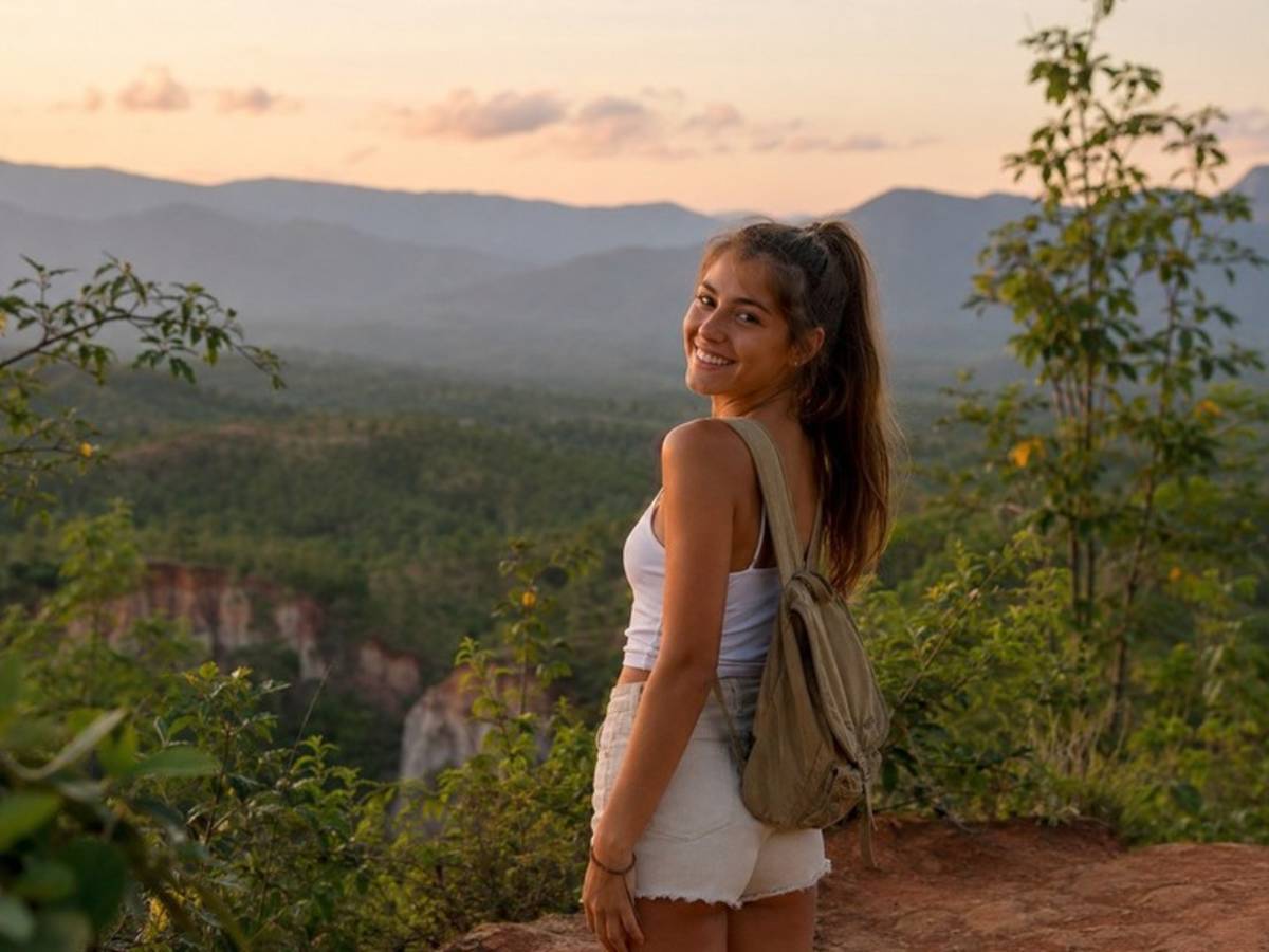 Solo traveller overlooking mountains in northern Thailand at sunset