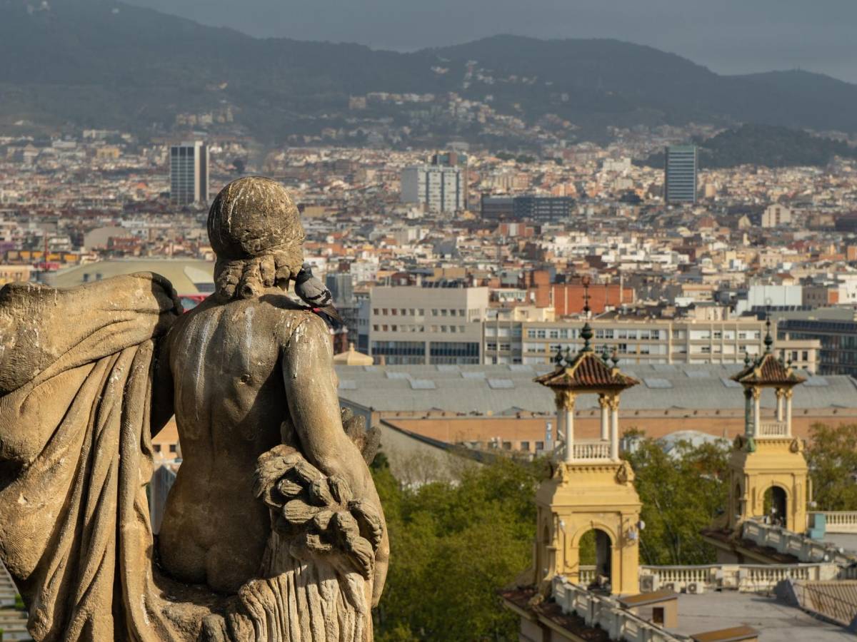 Statue overlooking Barcelona's cityscape.