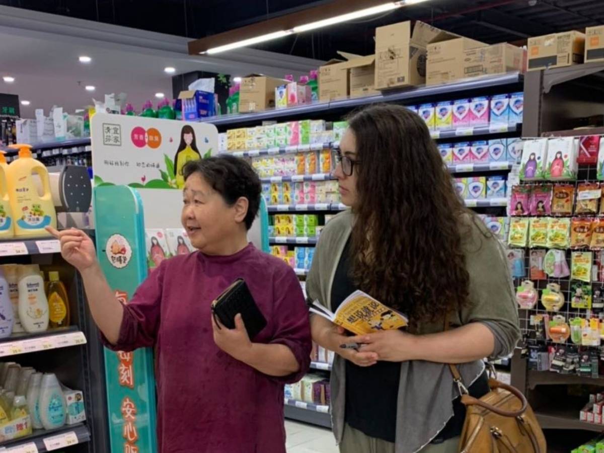 Student learning and practising Chinese in a local shop in Shanghai