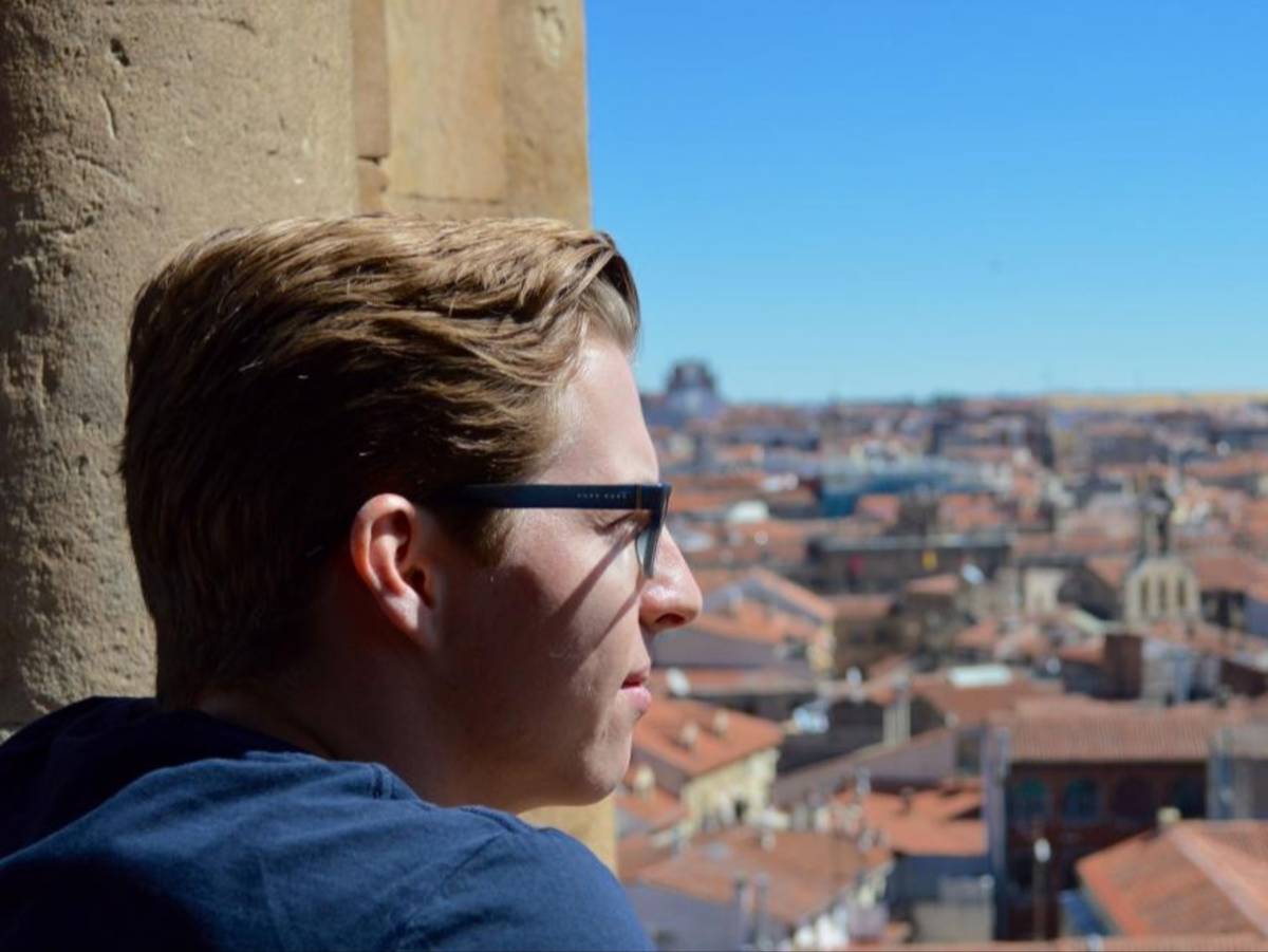 Student looking over Salamanca from a tower