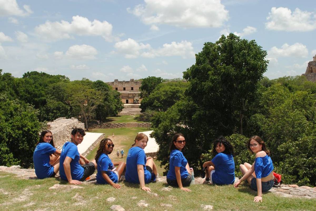 Student participants on hill overlooking Mayan ruins