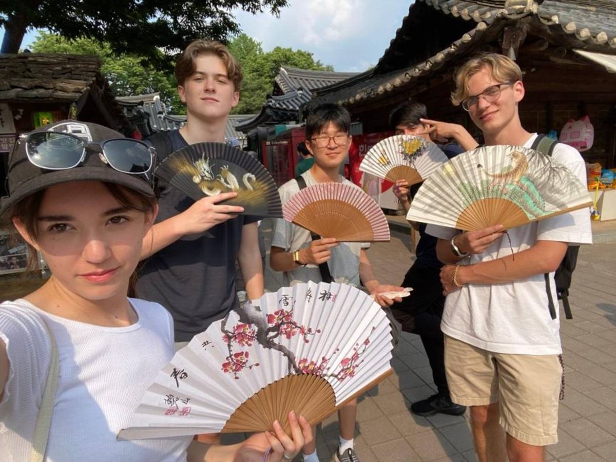 Student participants posing with fans