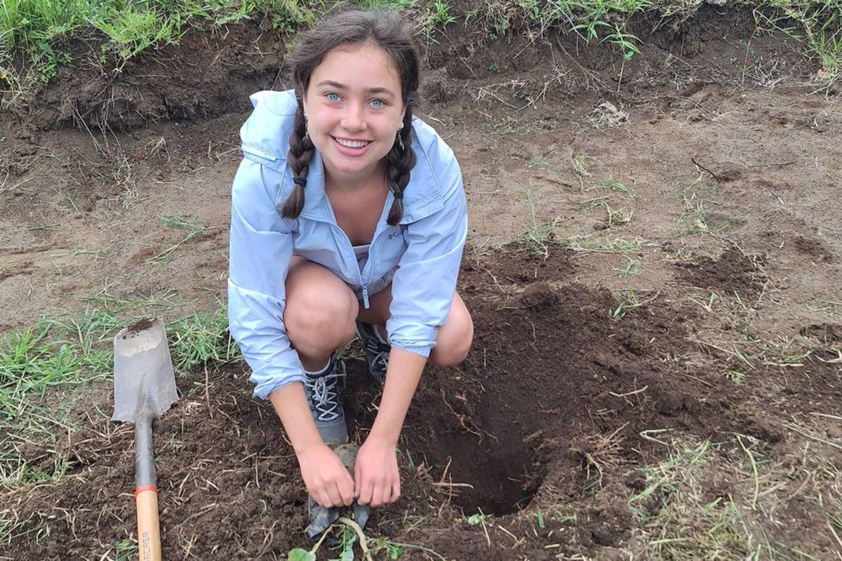 Student planting trees in Monteverde